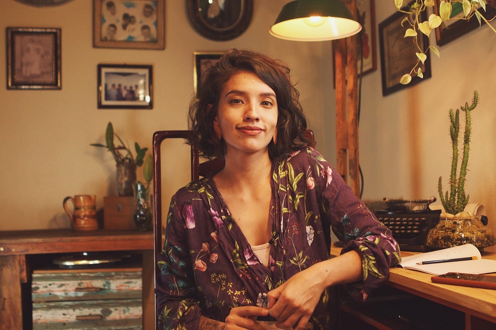 Isa está olhando para frente e sorrindo